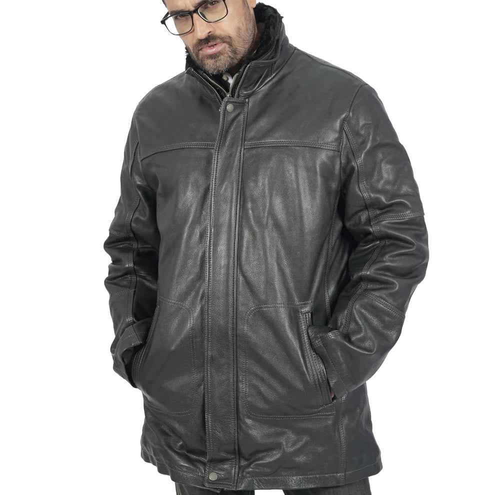Man wearing black leather jacket with zip front and high collar, hands in pockets, on white background