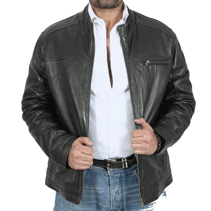 Man wearing black leather jacket, white button-down shirt, and blue jeans