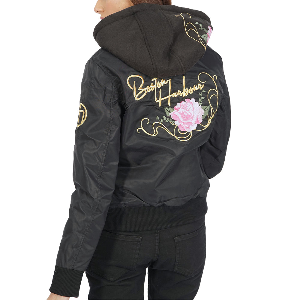 A woman wearing an Ibiza hooded black jacket with roses on it.