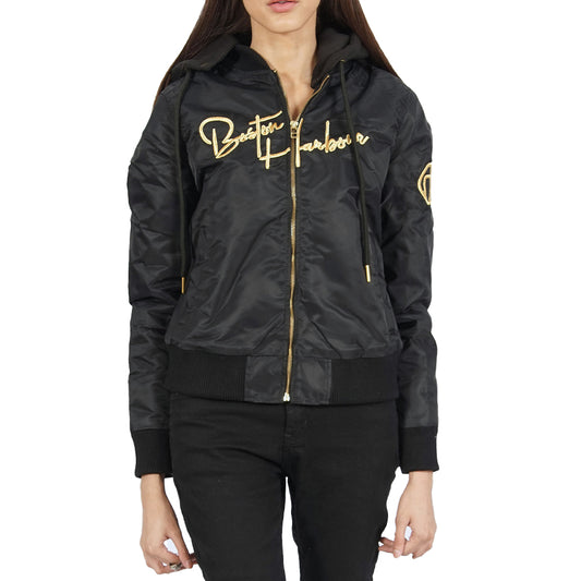 A woman wearing a Ibiza hooded black jacket with gold lettering.