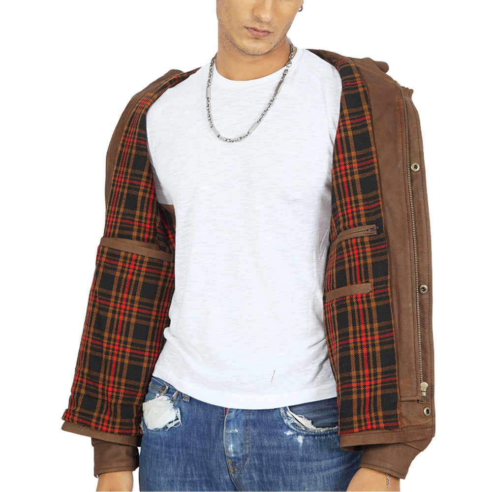 A man donning a vintage brown leather jacket and plaid shirt.