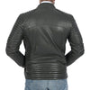 The back view of a woman wearing grey quilted leather jacket.