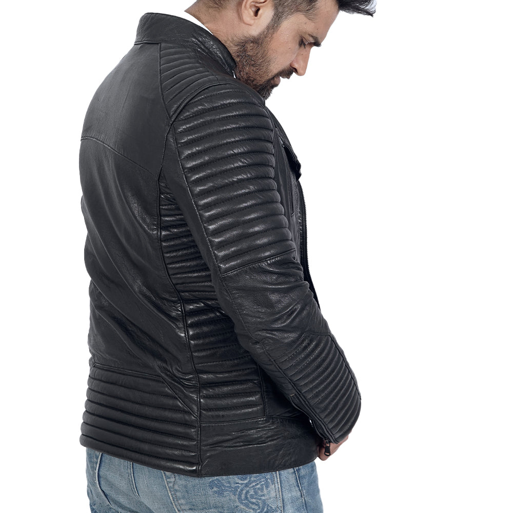 A man sporting a quilted black leather jacket.