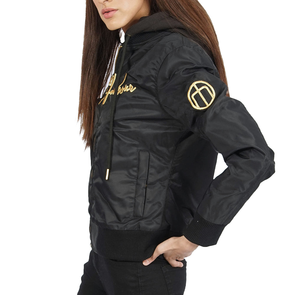 A woman wearing a Ibiza black bomber jacket embroidered in gold.