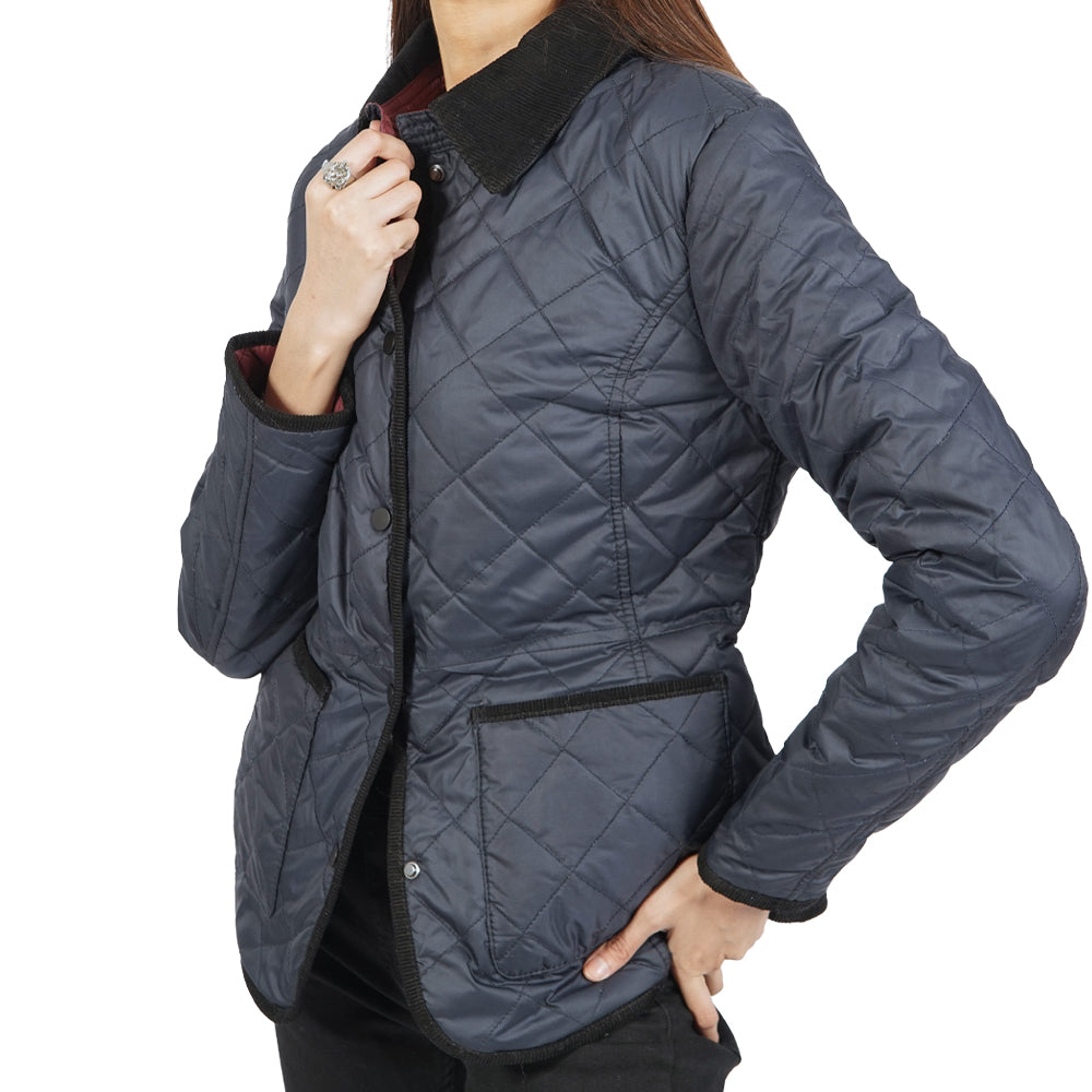 A woman donning a trendy blue quilted jacket.